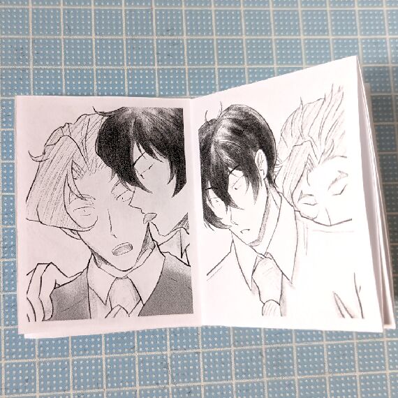 page left: Ainosuke looking surprised while Tadashi licks his cheek. page right: Tadashi has a surprised expression while Ainosuke kisses his back.